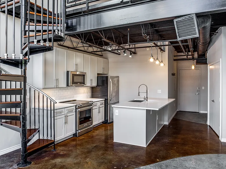 This split-level loft gives you ample space to spread your wings without feeling cramped in an apartment, due in part to the natural light, 18 ft ceiling and open bedroom.