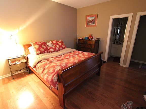 two bedrooms with walk in closets and hardwood floors