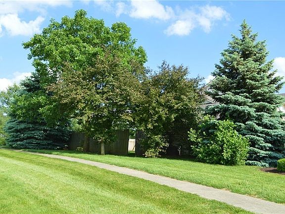 Lots of green all around. Home has privacy fence, you can see gate opening in picture..