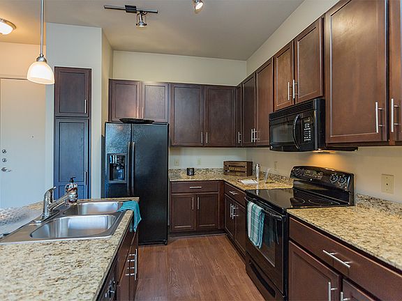 Granite countertops and 42" shaker-style cabinets with either espresso or light wash finish