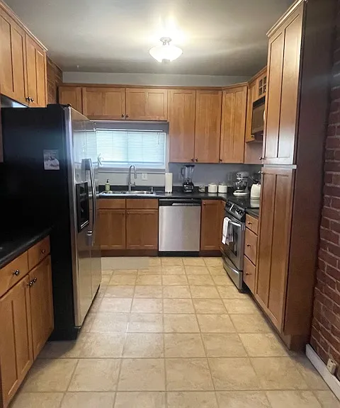 Large kitchen with exposed brick.