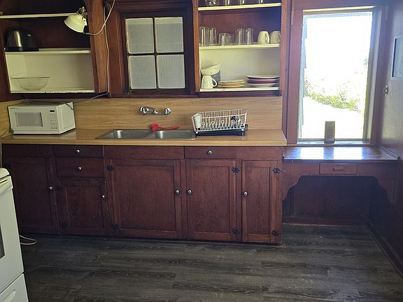 The charming kitchen invites you to gather and create, with its warm wood tones, ample counter space, and a cozy dining nook