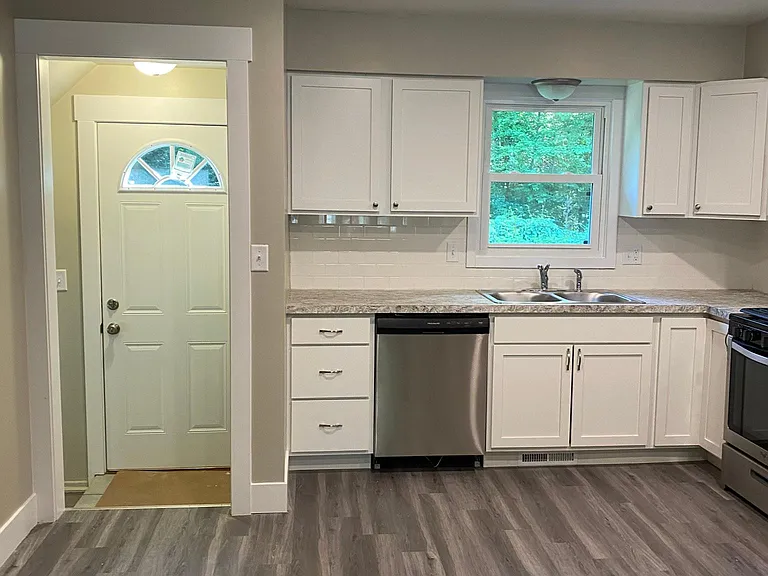 The door leads to the outside. 
To the left are steps going to basement