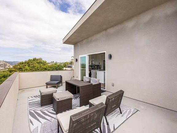 Another view of the large patio with the west facing views that make you feel like you are living on top of the trees. Very private.