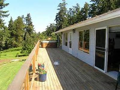 Living room and two bedrooms open to the expansive deck.