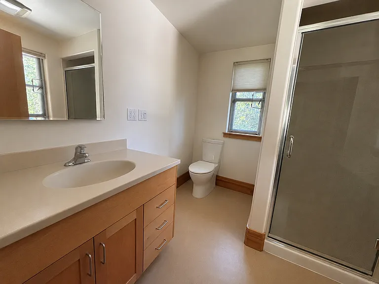 Roomy bathroom attached to the upstairs primary bedroom. Walk-in shower and lots of natural light.