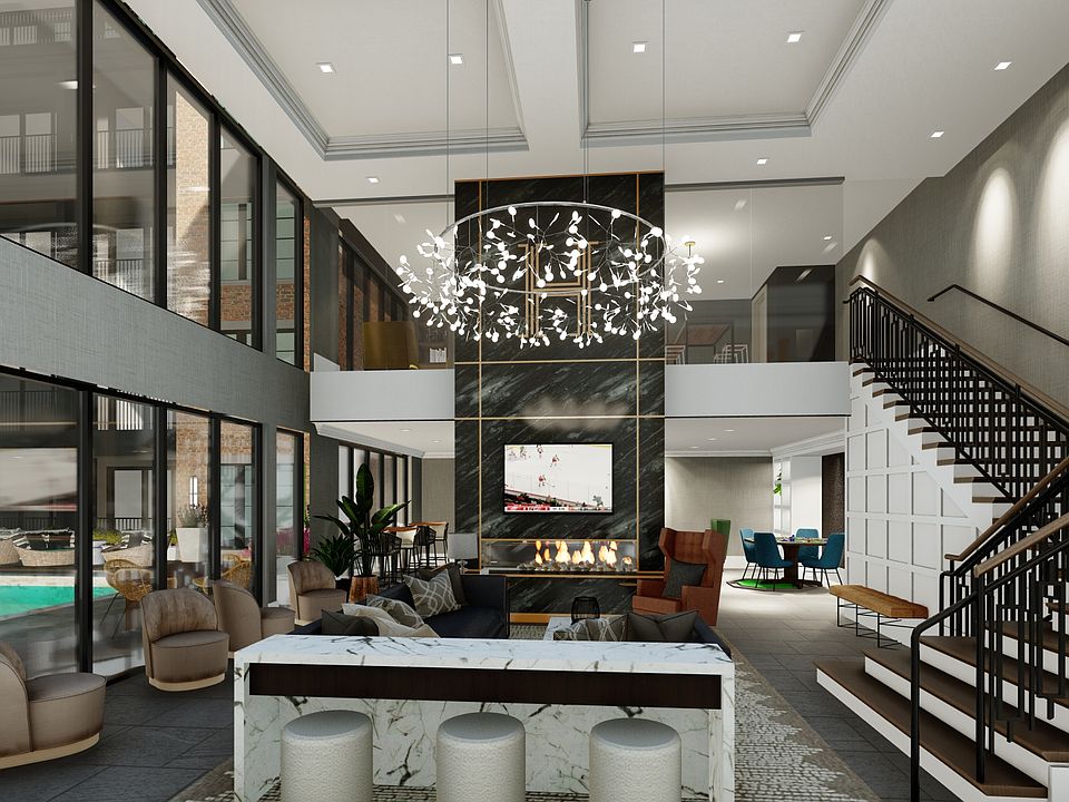 Two Story Communal Lounge Overlooking Sparkling Pool and Sundeck