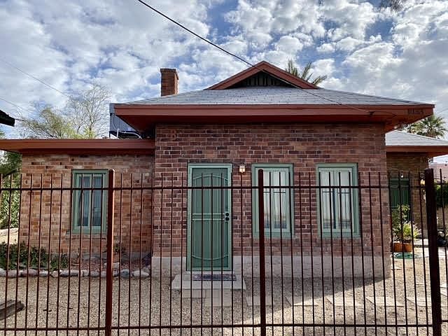 Front facade. Note the wrought iron fencing and security door.