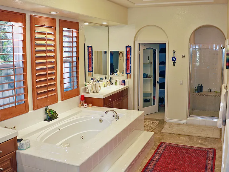 The Master Bath is quite large, with separate sinks, lots of storage, a walk-in closet, shower, jacuzzi tub, private toilet.