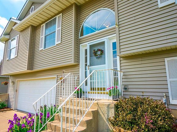 FRONT VIEW OF BEAUTIFUL HOME ON LARGE LOT, UPGRADED FRONT DOOR AND CONCRETE DRIVEWAY!
