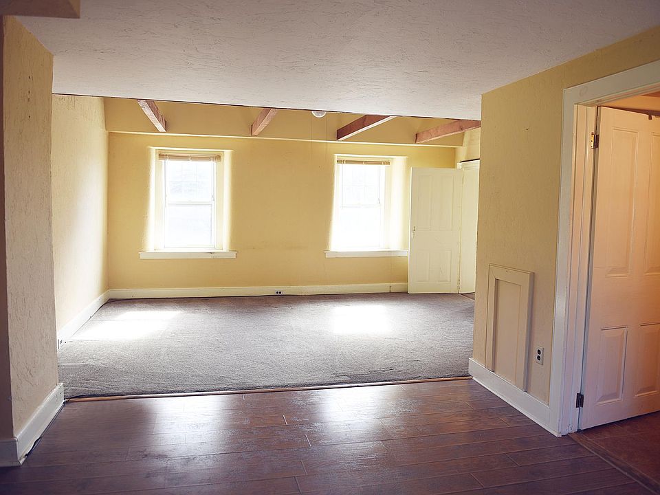 Bonus space with full bathroom to the right and large carpeted livingroom with vaulted ceiling ahead