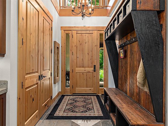 You'll find details such as the exquisite woodwork and unique lighting accents like this overhead chandelier throughout the entire home.>