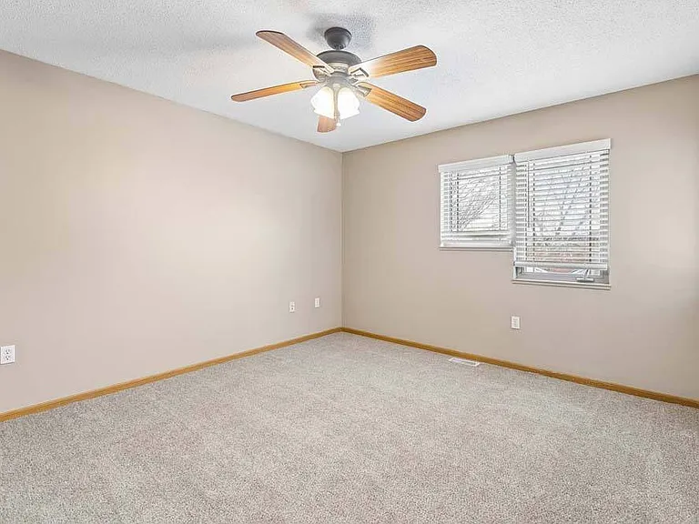A comfortable, light-filled bedroom that offers a calming space to relax and recharge.