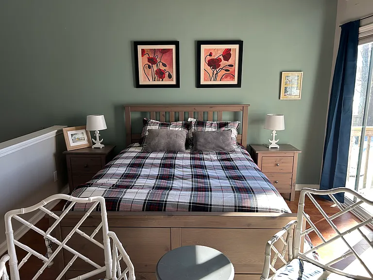 primary bedroom with sliding glass door to second floor deck