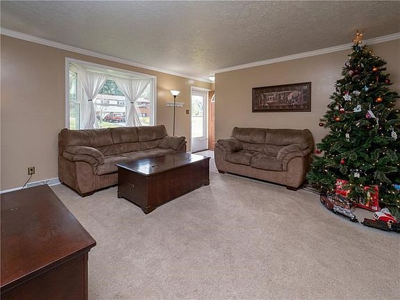 The oversized bay window floods the room with natural lighting.