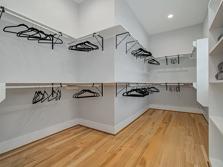 Spacious walk-in closet with ample storage for clothing, luggage, and personal belongings_ideal for extended stays and traveling professionals.