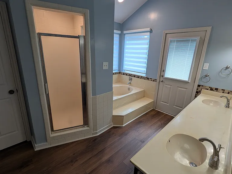 The main bedroom has this spacious, bright and airy attached bath suite with private toilet area.
