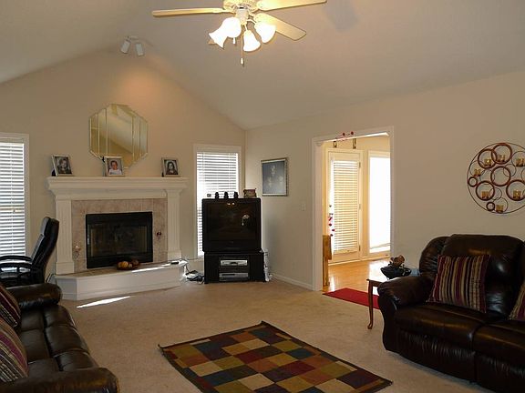 Spacious Living Room with ceilng fan, vaulted ceilings and fireplace!