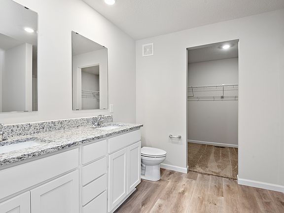 The master bathroom has a dual sink vanity and large closet.