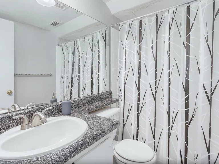 Bathroom with updated vanity, lighting, and shower