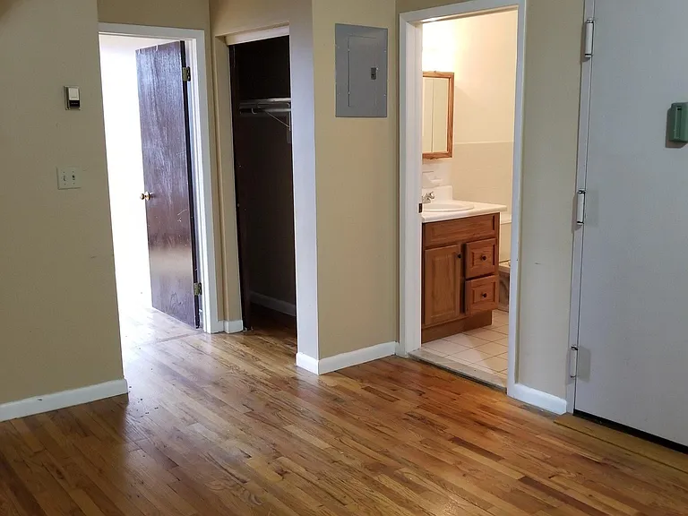 living room and view of bathroom double closet