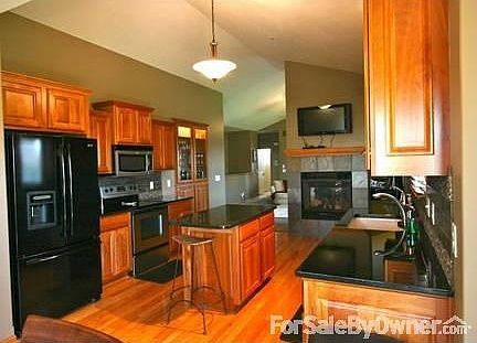 Kitchen
						:
						Beautiful cherry cabinets, granite countertops, & a cast iron sink.