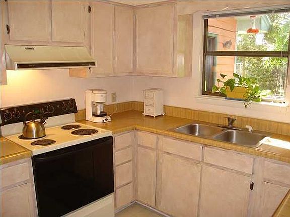 Kitchen is off of dining area and has a window looking out on private back yar