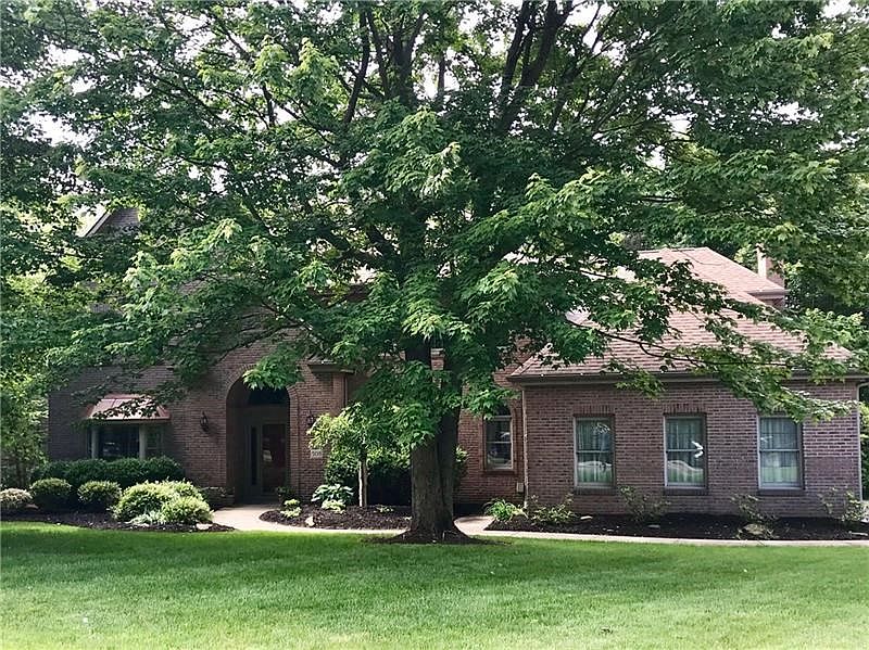Majestic brick colonial in Greenbriar Estates with level front yard and mature trees.