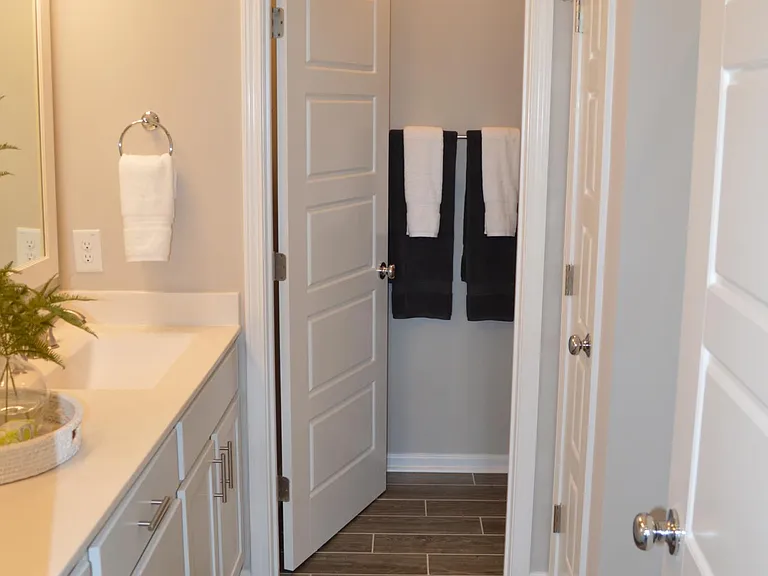 The master bath boasts two sinks, a large walk-in shower, a linen closet and a private toilet.