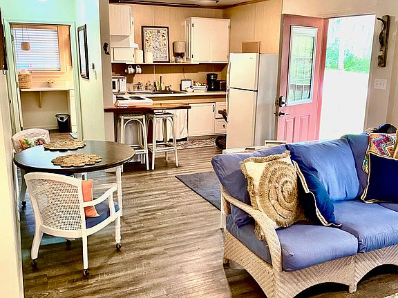 Kitchen area with stove, refrigerator, coffee maker, kitchen bar seating. All basic utensils and dinnerware are provided