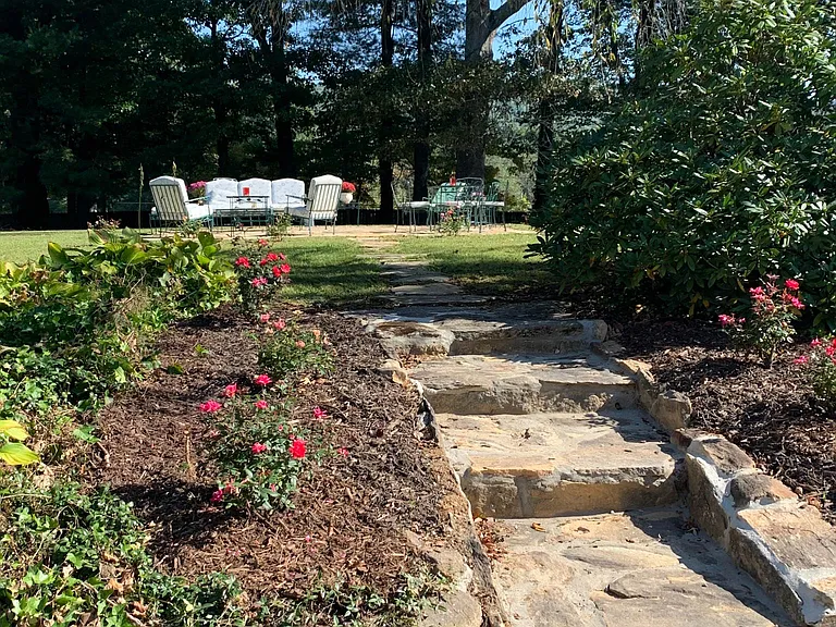 Front Yard stone patio with lounge furniture