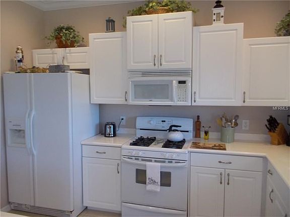 Staggered kitchen cabinets and solid surface counter tops.