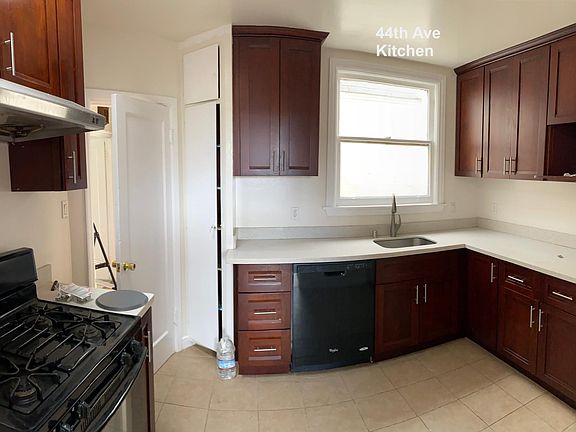 Kitchen - quartz counter top - dishwasher - refridge - range - exhaust fan