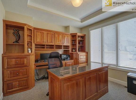 Desirable main level office with built in cabinets and desk.