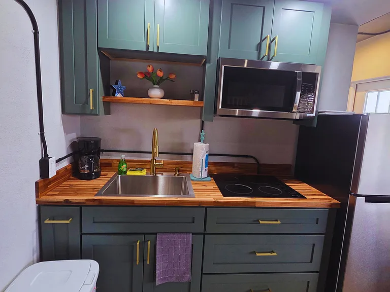 Bright and functional kitchen with essential amenities for a comfortable stay.