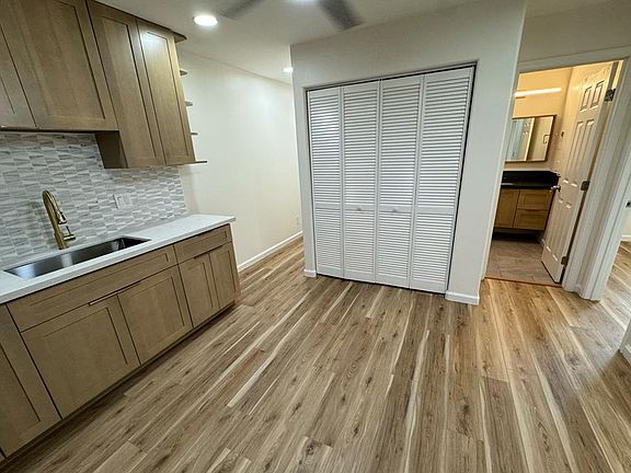 Another Kitchen view showing bathroom and closet containing laundry area