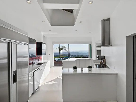 The kitchen seamlessly connects with the outdoors, allowing fresh air and natural light to fill the space.
