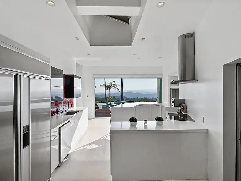 The kitchen seamlessly connects with the outdoors, allowing fresh air and natural light to fill the space.
