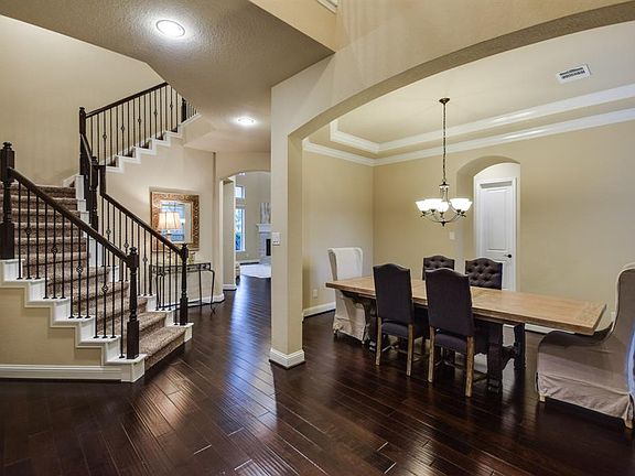 Elegant dining room with trayed ceilings and crown molding.