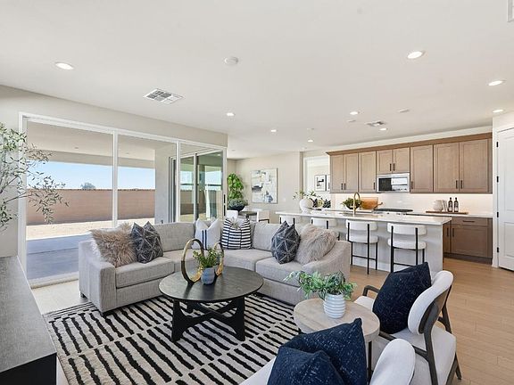Spacious great room with direct patio access seamlessly leads into casual dining area and kitchen