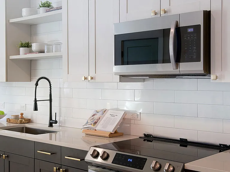 Sophisticated white countertops with subway tile backsplash and dark cabinets