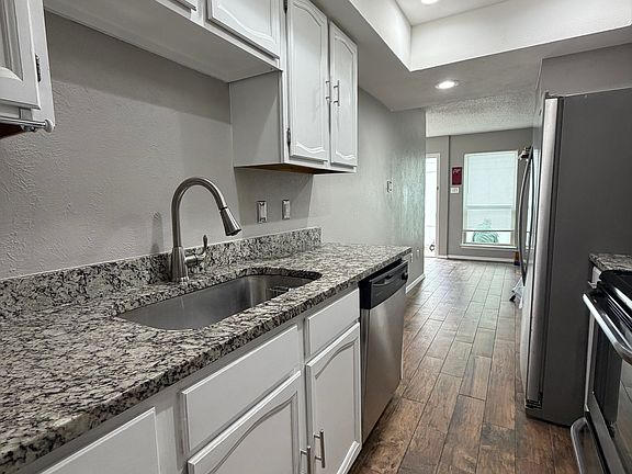 Kitchen with granite countertops and stainless steel.