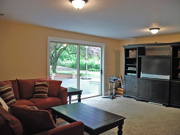 Family room with slider to large level backyard