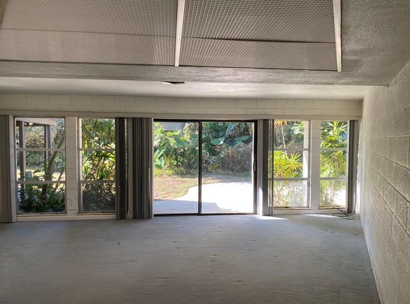 Spacious living room overlooking large backyard patio.