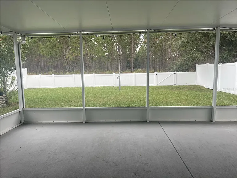 Spacious enclosed patio and fully fenced in yard overlooking conservation.