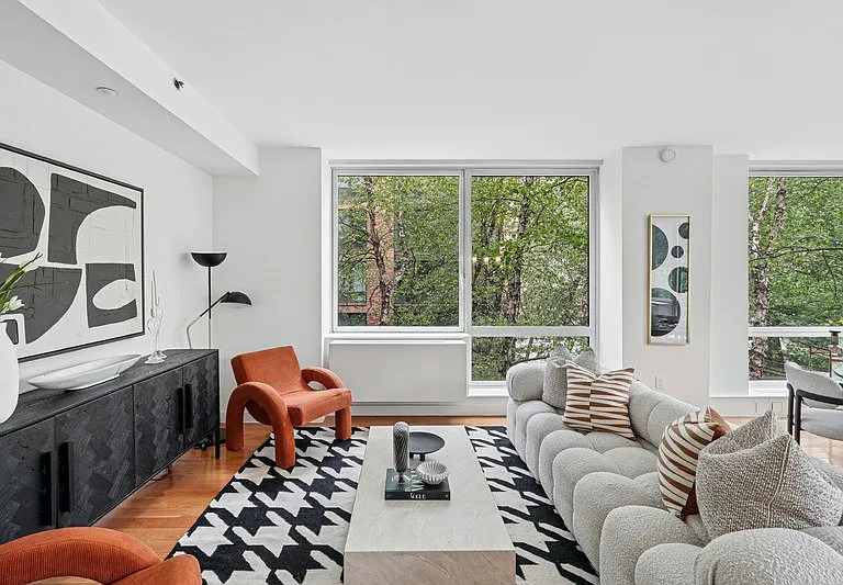 Step into the elegance of Arbor, where modern design meets comfort. This spacious living area boasts large windows that invite natural light, complemented by stylish furnishings and vibrant decor. Explore a space that redefines home. Schedule your visit t