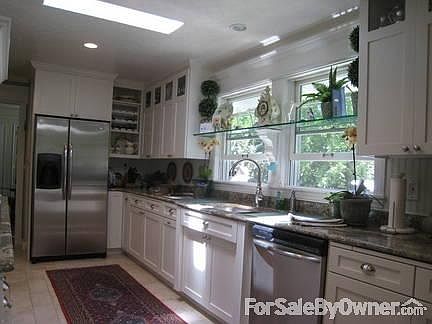 Cook's kitchen with granite counters
						:
						skylights, beautiful tile flooring, abundance of cabinet's