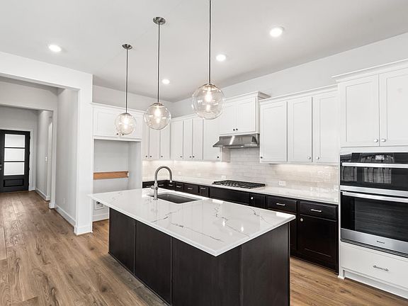 Chef-inspired kitchen with two-tone cabinetry and premium stainless steel appliances