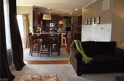 View from living room looking into kitchen and breakfast area. Butler's pantry and walk-in panty adjacent to kitchen. SS appliances, gas stove, granite countertops.