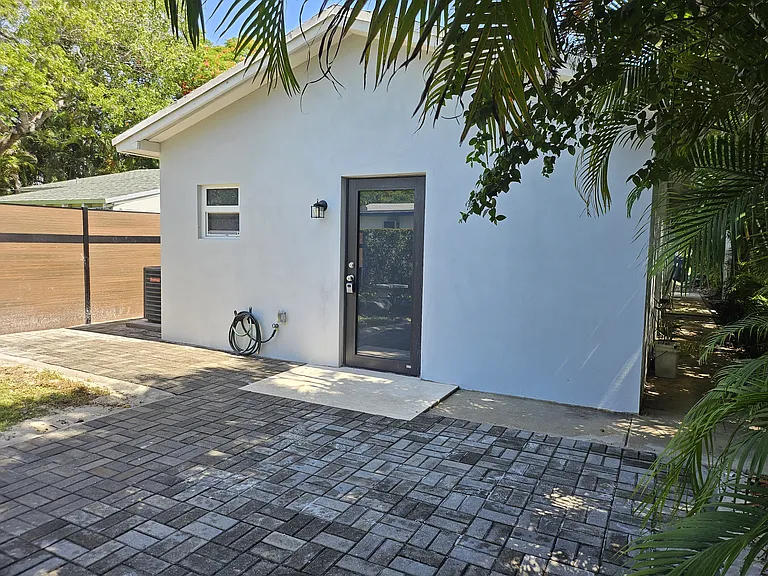Exit door to backyard paved patio and green area